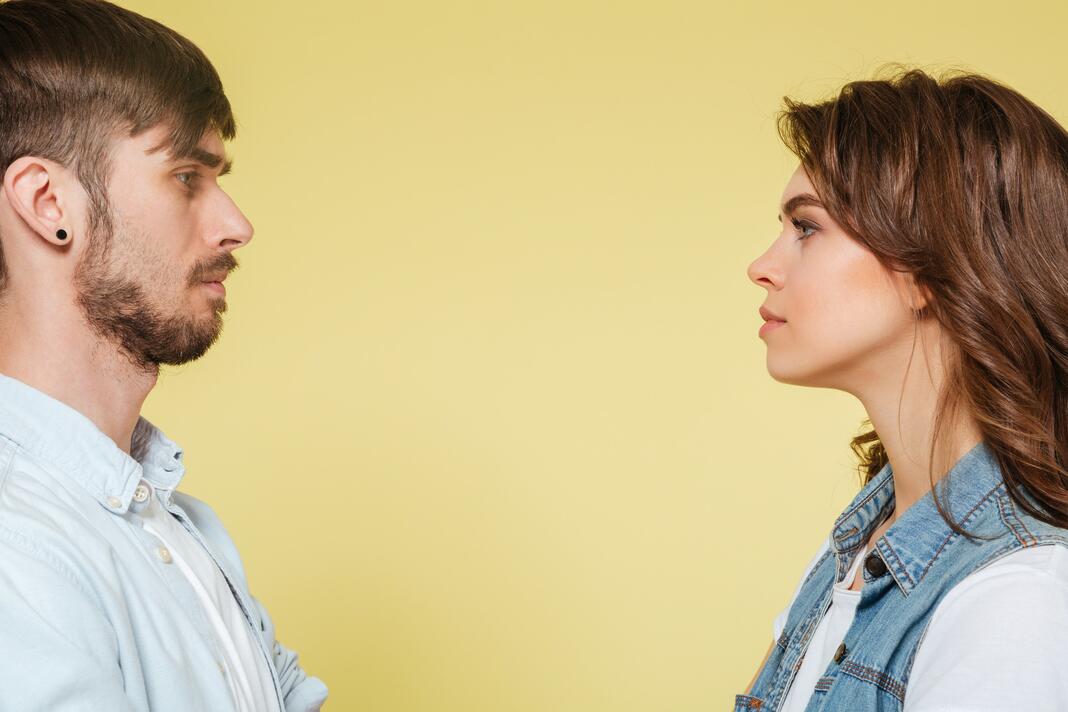 A man and woman looking at each other head on.